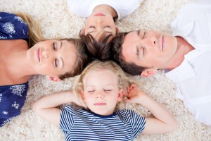 Relaxed family lying in circle on the wall-to-wall carpet